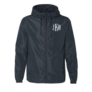 May include: A dark blue hooded jacket with a zipper closure and a white monogram that says "JKW" on the chest.