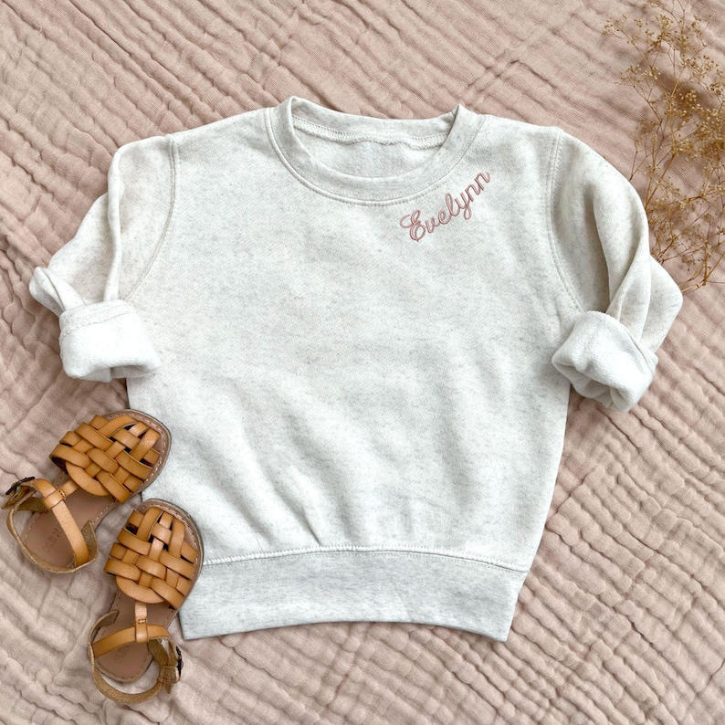 toddler natural heather crewneck sweatshirt with embroidered name along the collar