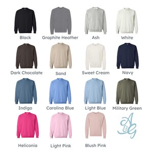 May include: A collection of crewneck sweatshirts in various colors, including black, gray, white, and shades of blue and pink. Each sweatshirt has a solid color and is displayed with its color name underneath.