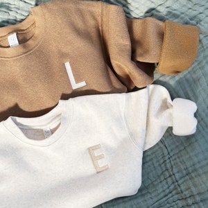 coyote brown and heather oatmeal toddler crew with a custom single letter embroidered design on the left chest