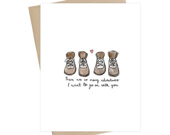May include: A white card with a hand-drawn illustration of three pairs of brown hiking boots and a small pink heart. The text reads "There are so many adventures I want to go on with you."