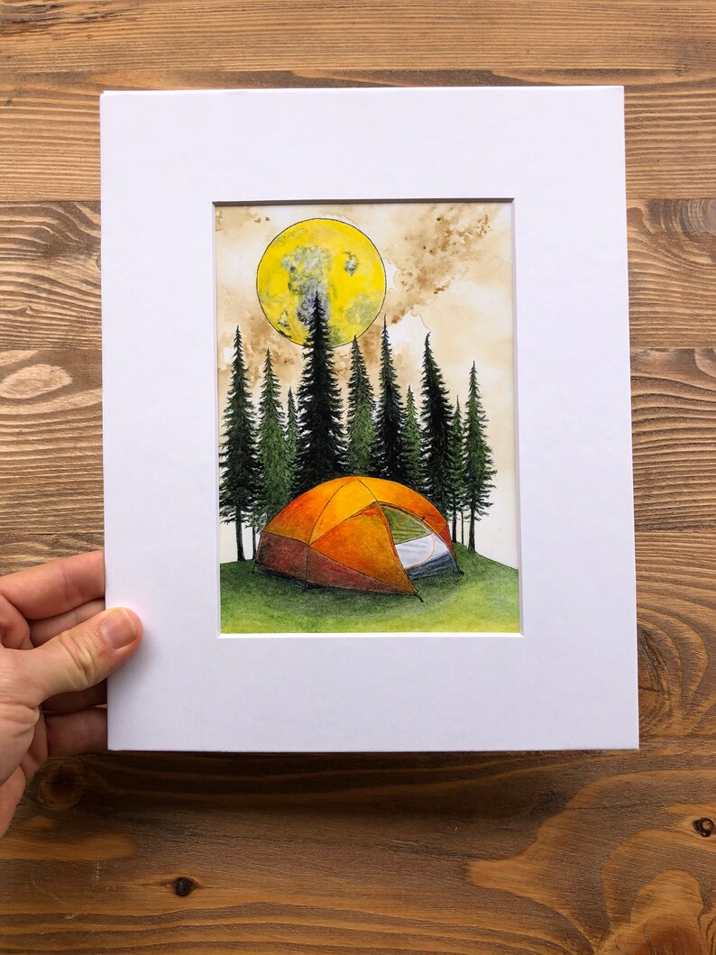 May include: A watercolor painting of a camping scene with a tent in the foreground, surrounded by a forest of pine trees. A large, yellow moon hangs in the sky above the trees.