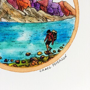 May include: A watercolor painting of a person with a backpack walking towards a lake in a mountainous landscape. The mountains are painted in shades of red, purple, and brown. The lake is a bright blue color. The painting is framed in a circle with a brown border. The artist's signature, "CRAIG PETERSON", is written in black ink at the bottom of the painting.