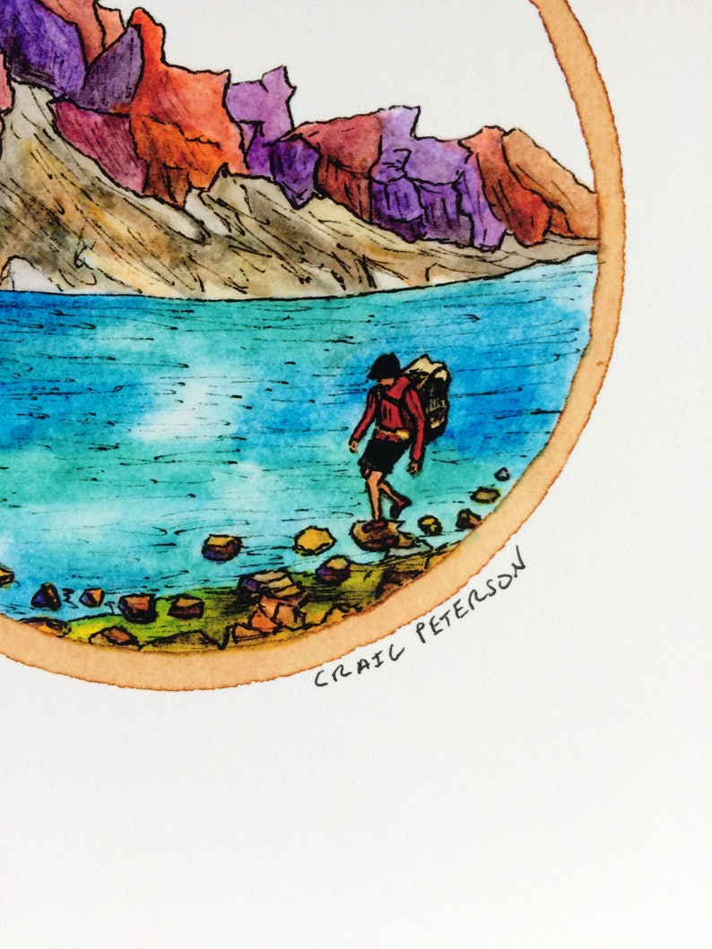 May include: A watercolor painting of a person with a backpack walking towards a lake in a mountainous landscape. The mountains are painted in shades of red, purple, and brown. The lake is a bright blue color. The painting is framed in a circle with a brown border. The artist's signature, "CRAIG PETERSON", is written in black ink at the bottom of the painting.