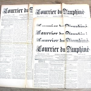 Könnte beinhalten: Eine Sammlung alter französischer Zeitungen mit dem Titel Courrier du Dauphiné, bestehend aus gealtertem cremefarbenem Papier mit schwarzem Text, Spalten und Schlagzeilen. Die Zeitungen sind gestapelt und zeigen historische Typografie.