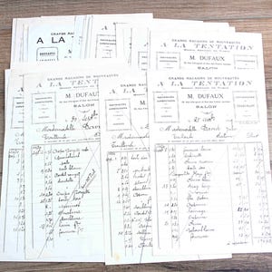 May include: A collection of vintage off-white paper invoices from Grands Magasins de Nouveautés A La Tentation, M. Dufaux. Each document features black printed headers, decorative borders, and handwritten French text detailing various textile items.