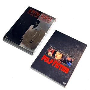 May include: Two DVD cases, one featuring Al Pacino in "Scarface" and the other with "Pulp Fiction." The "Scarface" DVD is a two-disc anniversary edition. The "Pulp Fiction" DVD is a collector's edition.
