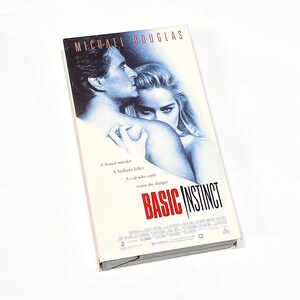 May include: A VHS tape case for the movie "Basic Instinct" starring Michael Douglas. The case features a photo of Michael Douglas and Sharon Stone.