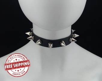 May include: Black leather choker with silver spikes. The choker is on a white mannequin. The image has a red stamp that says "On all US orders Free Shipping Above $35"