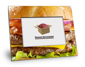 May include: A black picture frame with a close-up image of a large hamburger. The frame has a white mat and a small image of a brain inside a box with the text "Neurons Not Included" and the tagline "Accoutrements of Exceptional Brains".