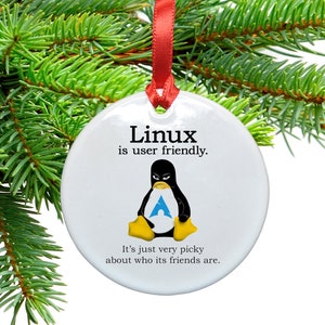 May include: White ceramic Christmas ornament with a penguin illustration and the text "Linux is user friendly. It's just very picky about who its friends are."