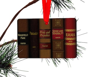 May include: A Christmas ornament featuring five book spines with the titles "Mansfield Park", "Persuasion", "Pride and Prejudice", "Sense and Sensibility", and "Emma". Each book spine is a different color and features gold accents.