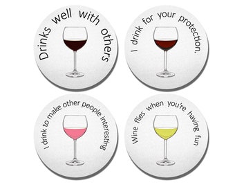 May include: Four round coasters with different wine glass illustrations and text. The text on the coasters reads: "I drink to make other people interesting", "I drink well with others", "Wine flies when you're having fun", and "I drink for your protection."