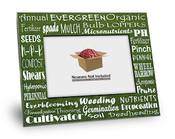 May include: A green picture frame with a white border and a brain inside a box. The frame is decorated with gardening terms such as "Annual", "Evergreen", "Organic", "Fertilizer", "Spade", "Mulch", "Bulb", "Loppers", "Micronutrients", "PH", "Seeds", "N-P-K", "Compost", "Shears", "Hydroponic", "Perennial", "Everblooming", "Weeding", "Nutrients", "Vernalization", "Thinning", "Germination", "Propagation", "Cultivator", "Soil", "Deadheading", "Fertilizer", "Pinch", "Biennial", "Wheel", "Barrow", "Aeroponic", "Prune".