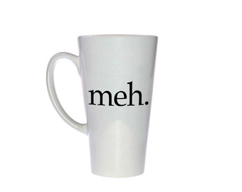 May include: White ceramic latte mug with a black inscription that reads "meh."