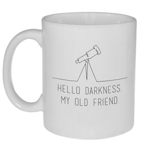 May include: White ceramic coffee mug with a black line drawing of a telescope and the text "HELLO DARKNESS. MY OLD FRIEND."
