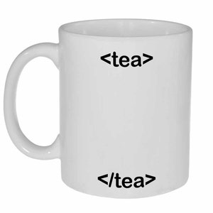May include: White ceramic mug with black text that reads "<tea>" and "</tea>" on the front.