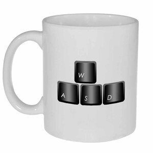 May include: White ceramic mug with a black and white image of computer keyboard keys, spelling out "WASD".