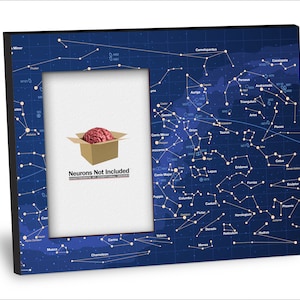 May include: A black picture frame with a blue background featuring a constellation map. The frame has a white mat and a picture of a brain inside a box with the text "Neurons Not Included" underneath.