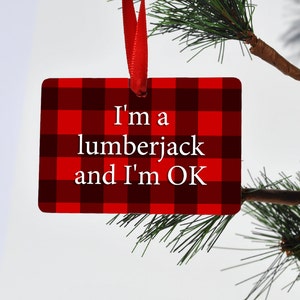 May include: Red and black plaid ornament with the text "I'm a lumberjack and I'm OK".