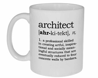 May include: White ceramic coffee mug with a black and white definition of the word "architect" printed on it. The definition reads: "[ahr-ki-tekt], n, 1. a professional skilled in creating artful, inspirational and socially meaningful structures that are eventually reduced to four concrete walls by bankers."