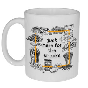 May include: White ceramic mug with a black and white illustration of various snacks, including pretzels, chips, popcorn, and potato chips. The text "just here for the snacks" is printed in black on the mug.