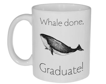 May include: White ceramic coffee mug with a black and white illustration of a whale and the text "Whale done, Graduate!"