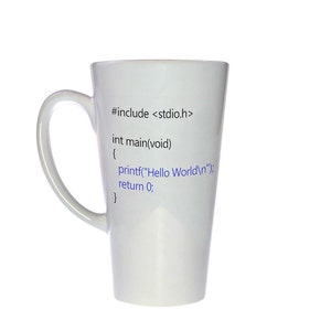 May include: A white ceramic mug with a tall, slender shape. The mug has a black handle and features a code snippet printed on the front: "#include <stdio.h> int main(void) { printf("Hello World
"); return 0; }"