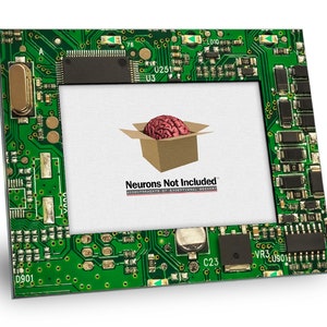 May include: A rectangular picture frame with a green circuit board design. The frame holds a white background with a cartoon brain in a cardboard box. The text "Neurons Not Included" is at the bottom.