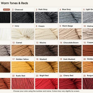 May include: A color chart displaying twenty-five yarn skeins labeled Neutrals, Warm Tones & Reds. The grid includes shades ranging from black, charcoal, and gray to white, beige, brown, mustard, orange, and various red tones numbered 1 through 25.