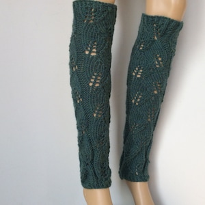May include: A pair of teal blue knitted leg warmers with a lacy pattern.