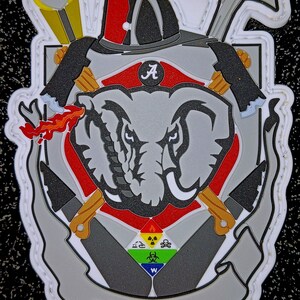 May include: A white patch with a red, white, and gray elephant head with a red background. The elephant head has a white tusk and a black eye. The patch has a white border with a stitched design. The patch has a red and white banner with the text "Crimson Flame" in black. The patch also has a white banner with the letter "A" in black. The patch has a white banner with a black and white symbol of a skull and crossbones, a radiation symbol, a fire symbol, and a biohazard symbol.