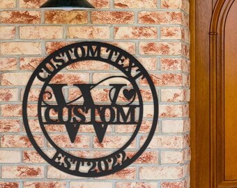 May include: Black metal monogram sign with the letters "V" and "W" and the text "CUSTOM TEXT EST 2022" on a brick wall background.
