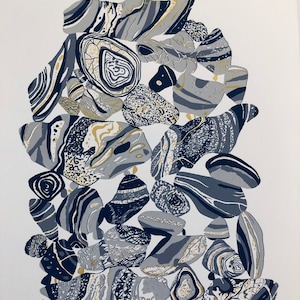 May include: A black and white print of a pile of stones with gold accents. The print is titled "From the Fortymile" and signed "Studio Friday".
