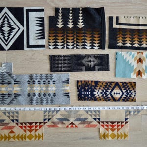 May include: Seven rectangular fabric swatches with geometric patterns in black, white, gray, blue, tan, and orange. A yellow measuring tape shows a length of 36 inches, and a vertical yellow measuring tape shows a height of 26 inches.