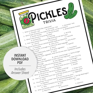 May include: A white sheet with "PICKLES TRIVIA" printed in black, featuring a jar and pickle graphic. The sheet includes trivia questions about pickles, with multiple-choice answers. The background is filled with fresh green cucumbers.