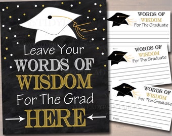 May include: Black chalkboard sign with gold text that says "Leave Your Words of Wisdom For The Grad Here".  A white graduation cap with a gold tassel is in the top left corner.  Three white cards with black graduation caps and gold text that says "Words of Wisdom For The Graduate" are on the right side of the image.