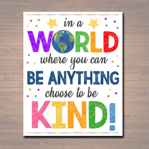Könnte beinhalten: Ein farbenfrohes Poster mit dem Text "in a WORLD where you can BE ANYTHING choose to be KIND!" Der Text ist in einem Regenbogen von Farben geschrieben und hat eine kreidige Textur. Ein kleines Bild der Erde befindet sich in der Mitte des Wortes "WORLD".