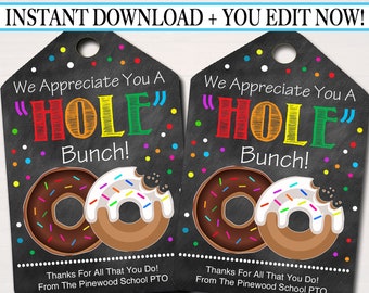 May include: Two black chalkboard-style gift tags with a donut theme. The text reads "We Appreciate You A "HOLE" Bunch!" with a rainbow colored "HOLE". The tags have a donut graphic with sprinkles and chocolate frosting.