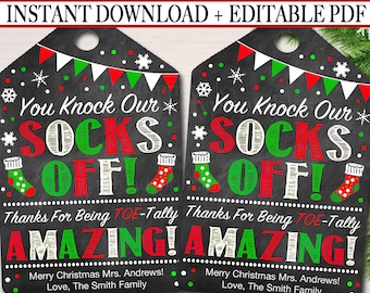 May include: Two printable Christmas gift tags with a chalkboard background. The tags feature red and green socks with the text "You Knock Our Socks Off! Thanks For Being Toe-Tally Amazing! Merry Christmas Mrs. Andrews! Love, The Smith Family."