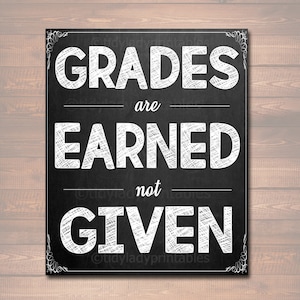 May include: Black and white chalkboard sign with the text "GRADES are EARNED not GIVEN".