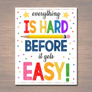 Könnte beinhalten: Ein Motivationsposter mit dem Text "alles ist schwer, bevor es leicht wird!" in Regenbogenfarben mit einem gelben Bleistift, der in der Mitte gezeichnet ist. Der Hintergrund ist weiß mit bunten Punkten.