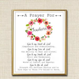 May include: A framed print with a gold border. The text "A Prayer For Teachers" is displayed, encircled by a floral wreath in pink, red, and green hues. The prayer includes requests for compassion, understanding, and strength.
