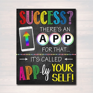 May include: A chalkboard sign with the text "Success? There's an App for that... It's called App-ly Your Self!" The sign is decorated with rainbow colours and a smartphone icon.