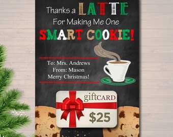 May include: A chalkboard with a Christmas-themed gift card design. The text reads "Thanks a Latte for Making Me One Smart Cookie!" with a coffee cup and a gift card with a red bow and the text "giftCARD $25".