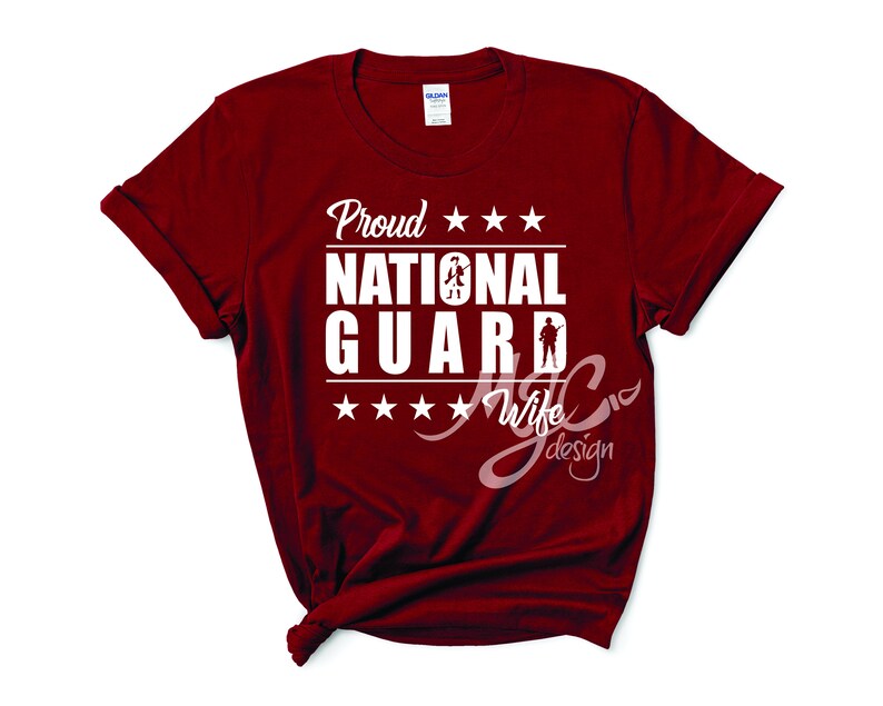 May include: Red t-shirt with white text that reads "Proud National Guard Wife". The text is surrounded by five white stars.