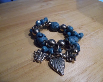 Faux Turquoise Stretch Bracelet With Silver Beads And Heart, Stars,And Elephant Charms.