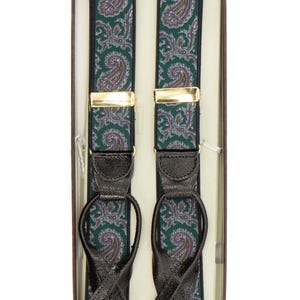 May include: Green paisley suspenders with black leather loops and gold-tone metal clasps, presented in a brown box. The suspenders feature a detailed pattern in shades of green, purple, and white.