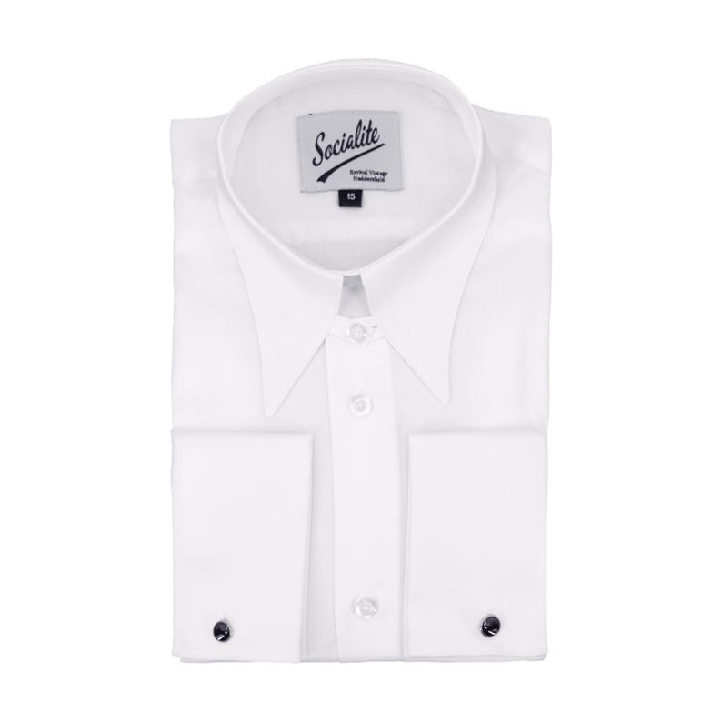 May include: A crisp white long-sleeve dress shirt featuring a pointed collar and French cuffs secured with dark circular cufflinks. The inner neck label displays the text Socialite, Revival Vintage, Haddenham, and the number 15.