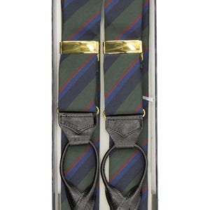 May include: Green, blue, and red striped braces with gold-coloured clasps and black leather detailing. The braces are presented in a black box, a classic accessory for formal or business wear.